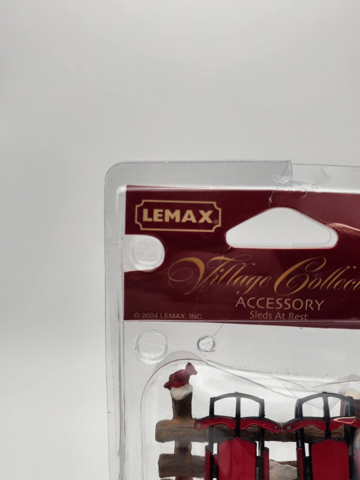 Christmas Village Accessory Sleds At Rest Sleds on Fence Lemax Village 44226CV