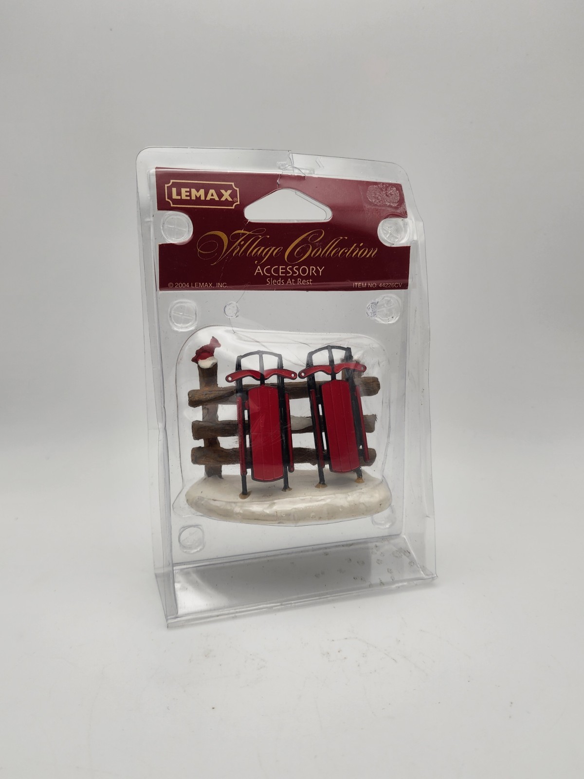 Christmas Village Accessory Sleds At Rest Sleds on Fence Lemax Village 44226CV