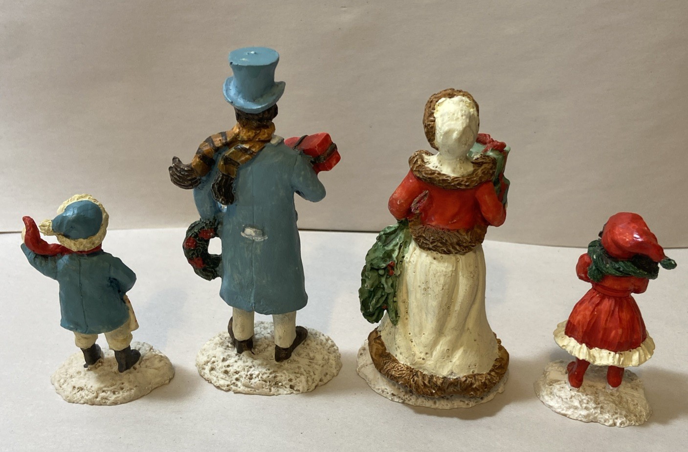 Set Of 4 Resin Christmas Village Family Figurines