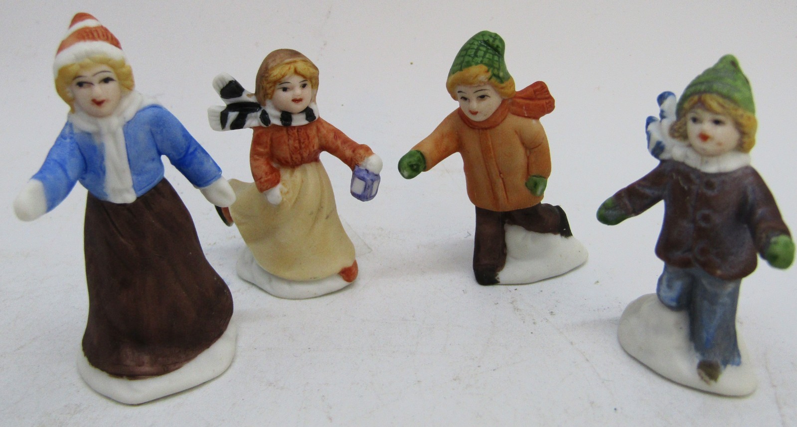 Vintage 4 Porcelain Christmas Village Figurines + 2 Metal Lampposts.