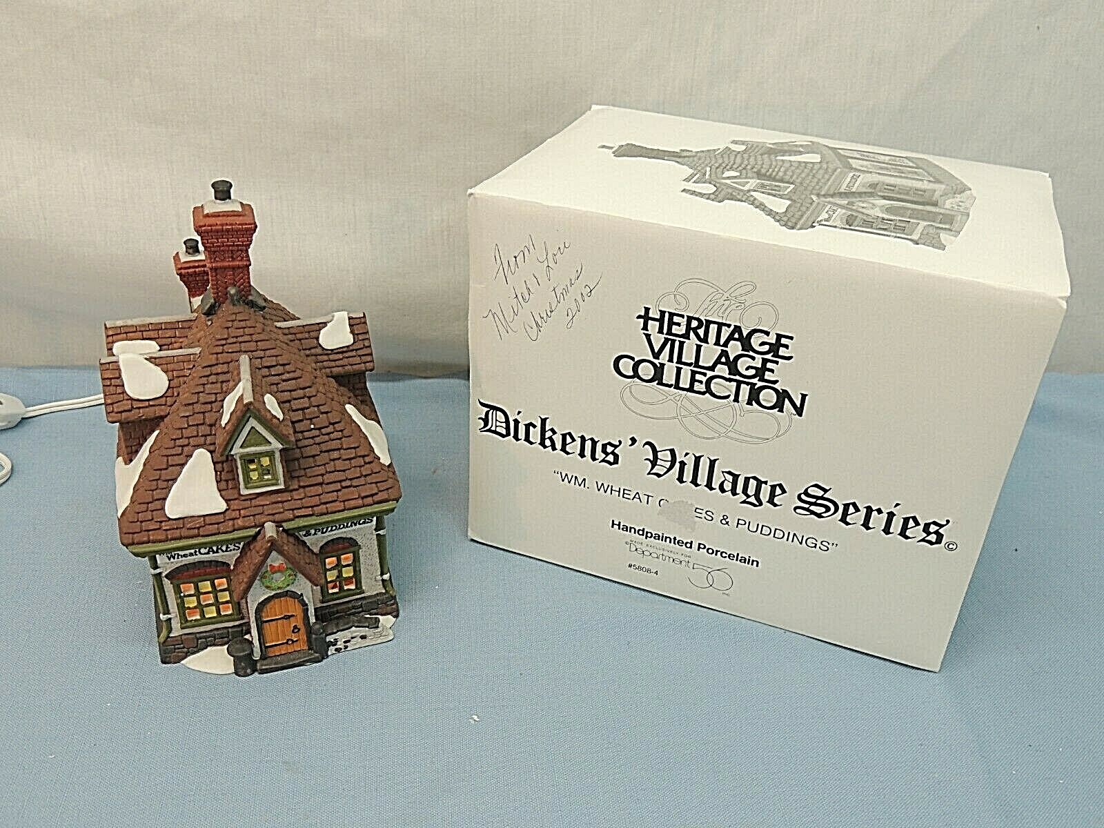 HERITAGE VILLAGE COLLECTION, DICKENS’ VILLAGE,”WM. WHEAT CAKES & PUDDINGS”