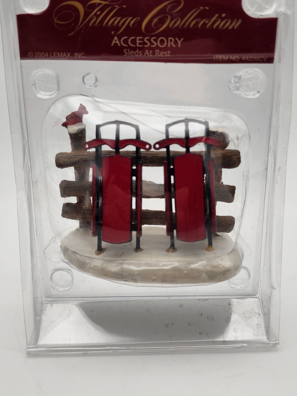 Christmas Village Accessory Sleds At Rest Sleds on Fence Lemax Village 44226CV