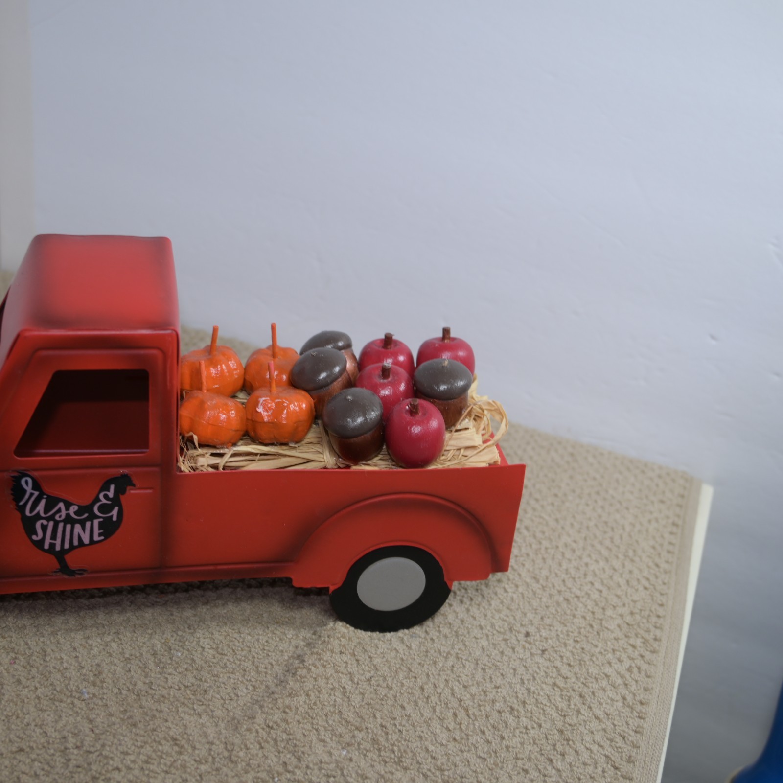 metal autumn decoration truck with pumpkins and apples and acorns in the back