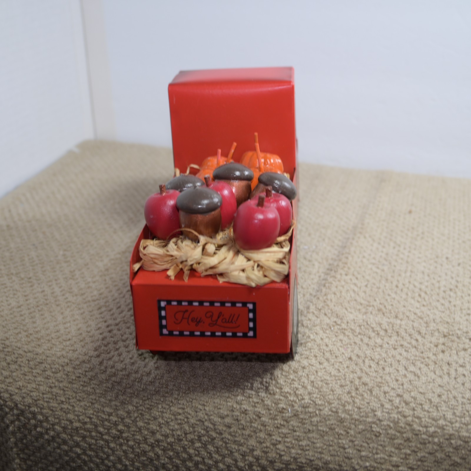 metal autumn decoration truck with pumpkins and apples and acorns in the back
