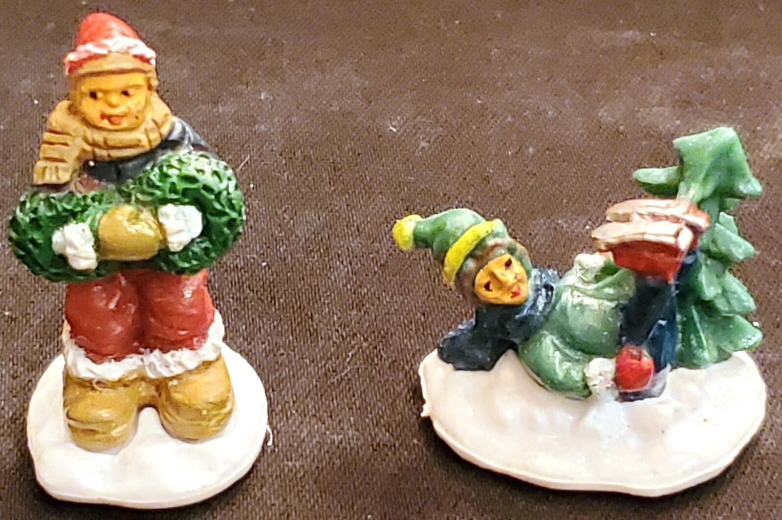 Christmas Village 2 small plastic figures ICE SKATER FELL & KID WITH WREATHS