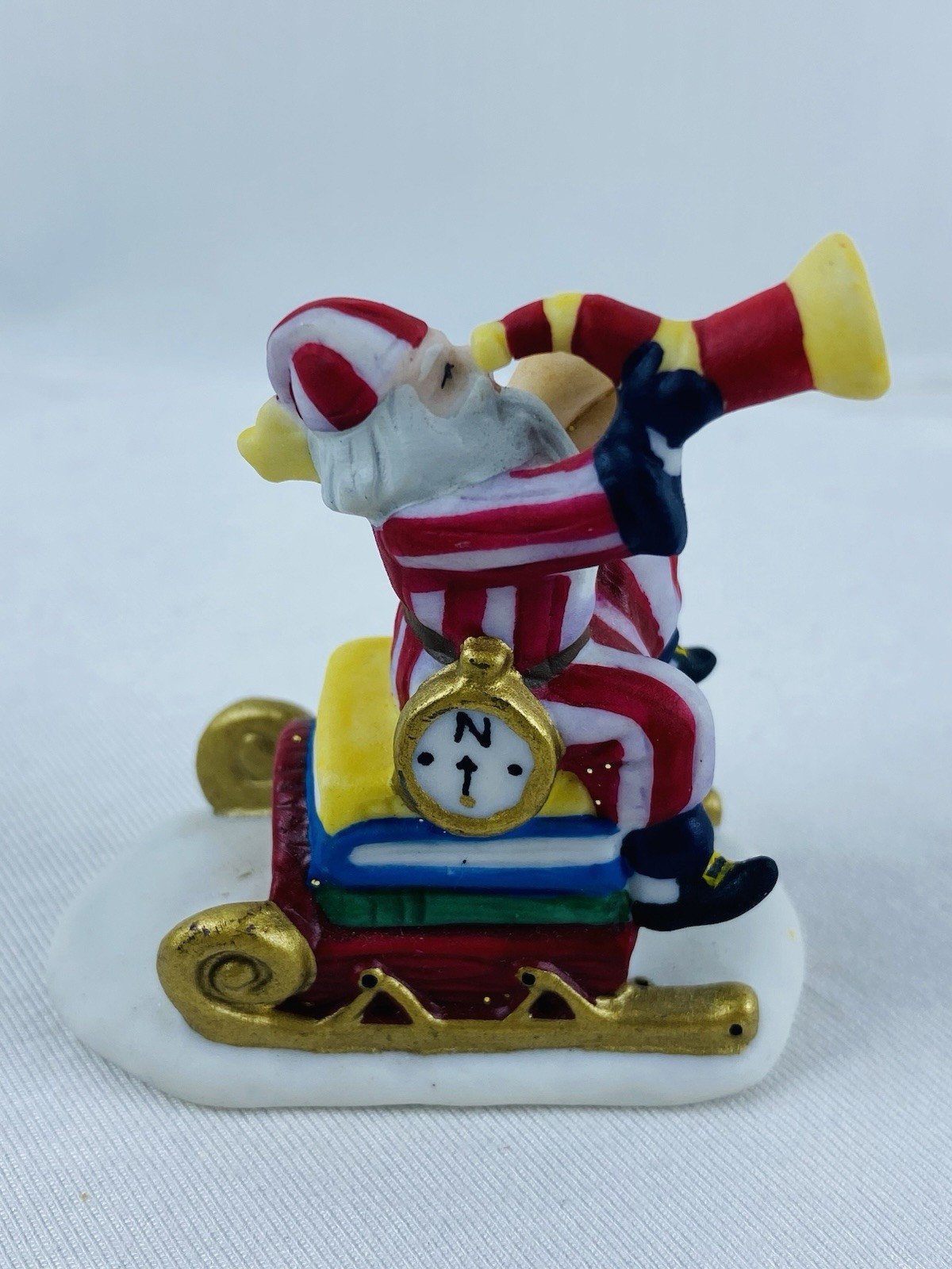 Department 56 H.V. Series Santa Claus In Red & White Striped Pajamas On A Sled