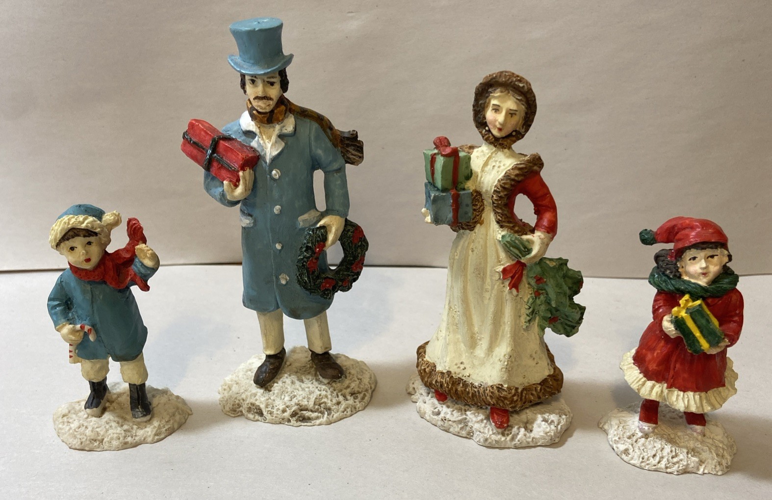 Set Of 4 Resin Christmas Village Family Figurines