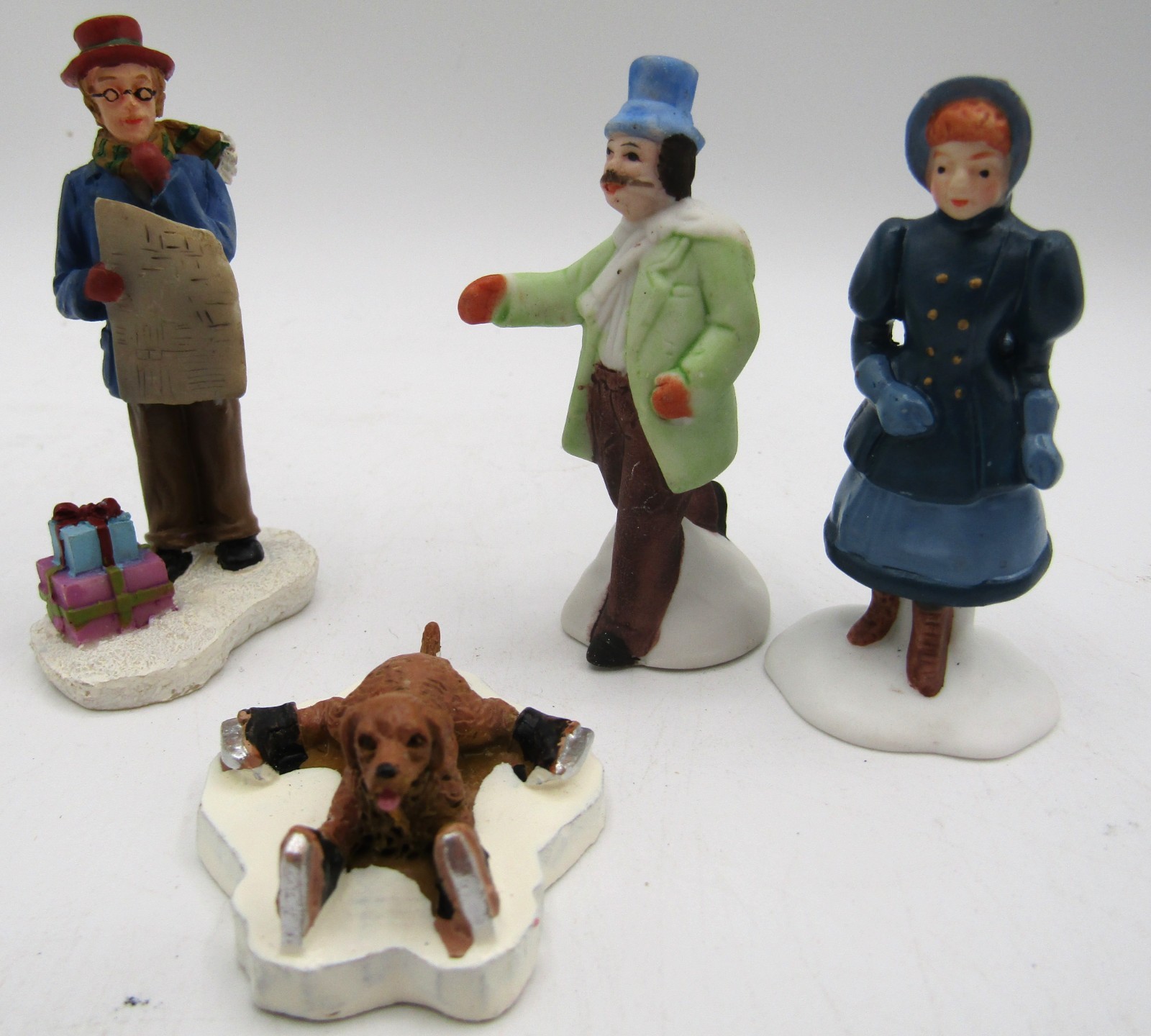 Assorted Ceramic Christmas Village Figurines. Set of 4.