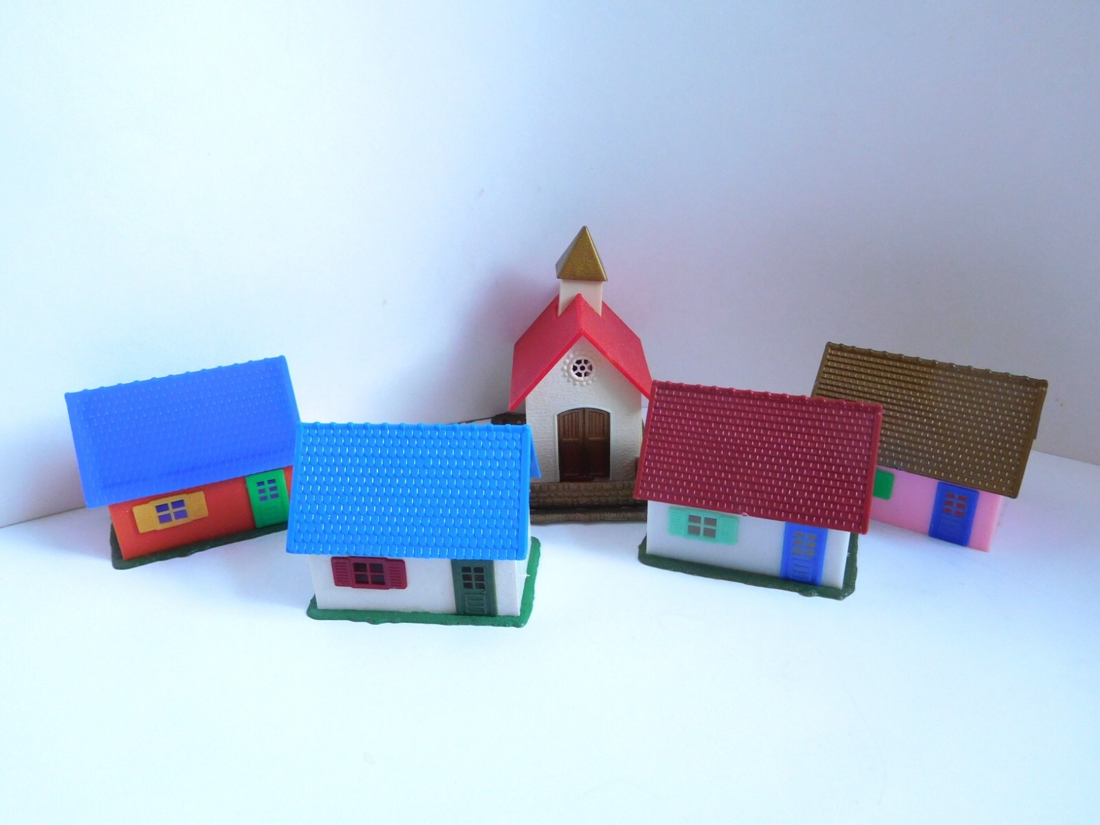 Plastic miniature village houses and church for under tree or train setup