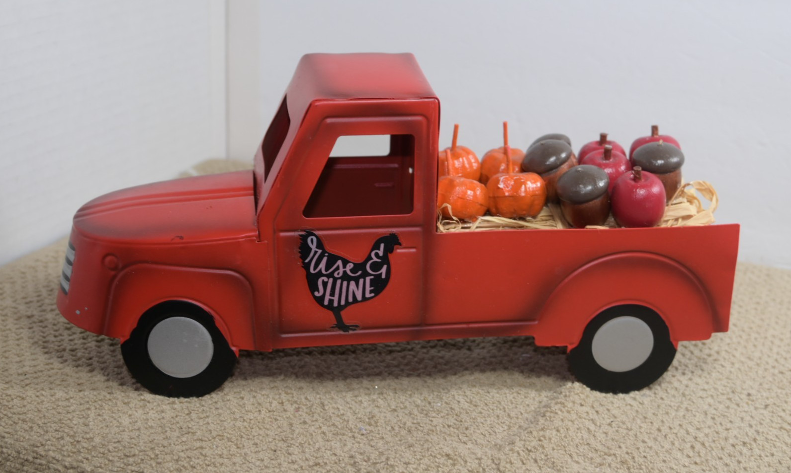 metal autumn decoration truck with pumpkins and apples and acorns in the back