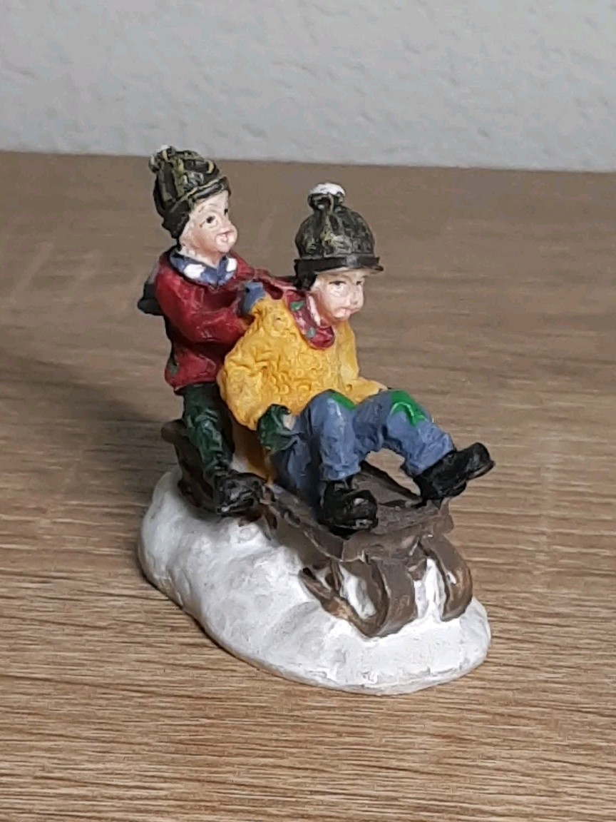 Christmas Village Figurine Features Kids Sledding