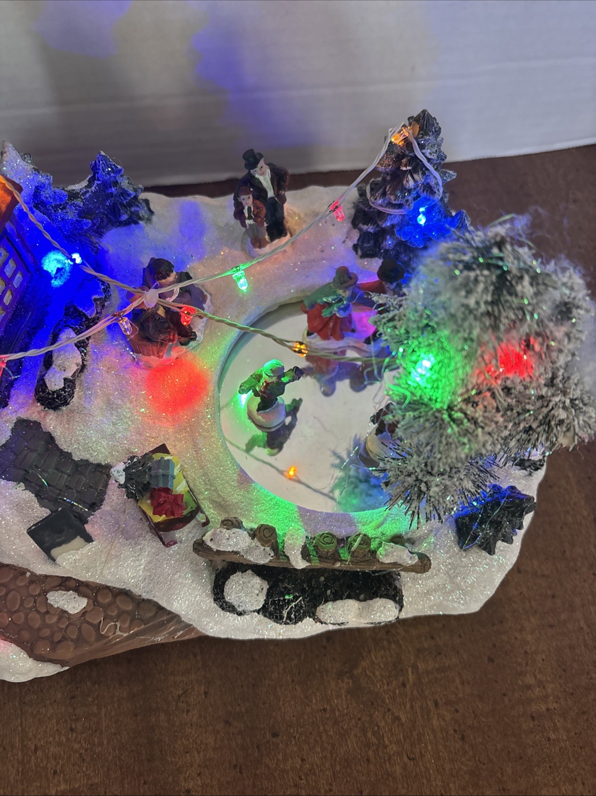 Christmas village Ice Skating Plaza rink lights up plays songs Skaters skate