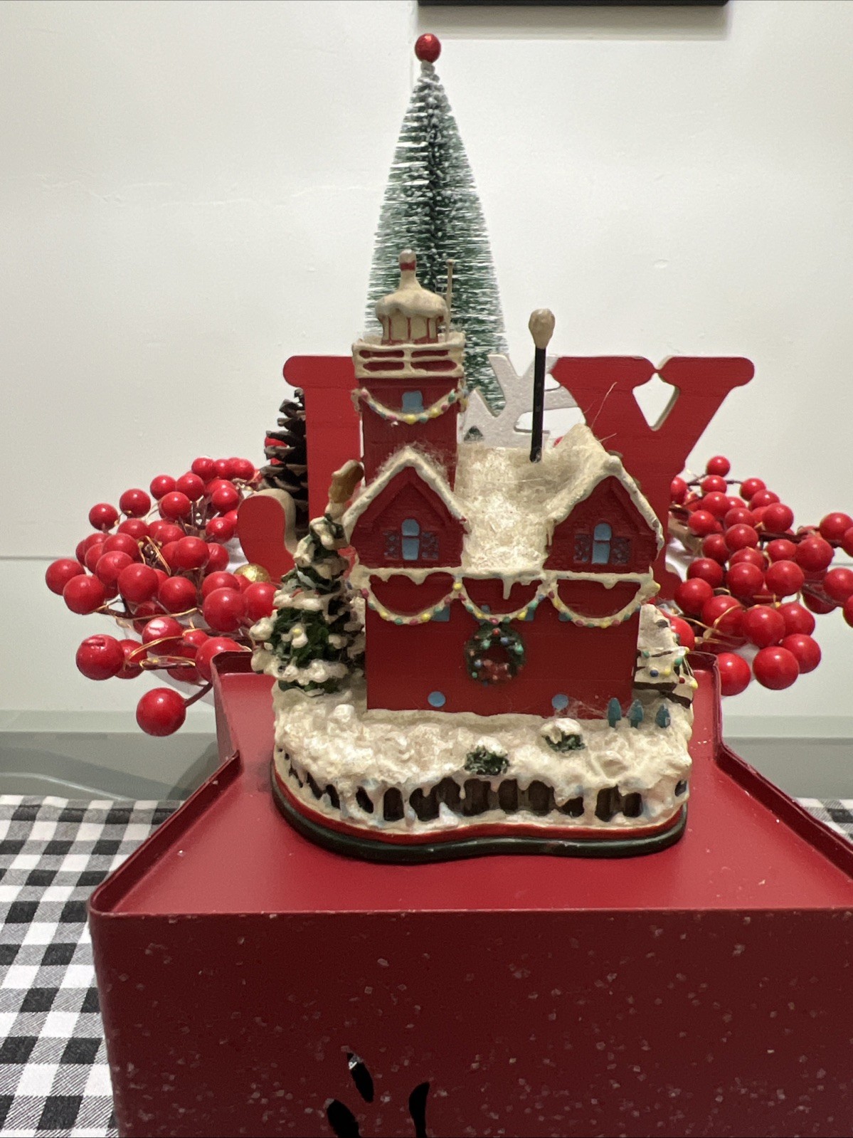Holiday Charm Cortland Church. Christmas scene a red house with a lighthouse