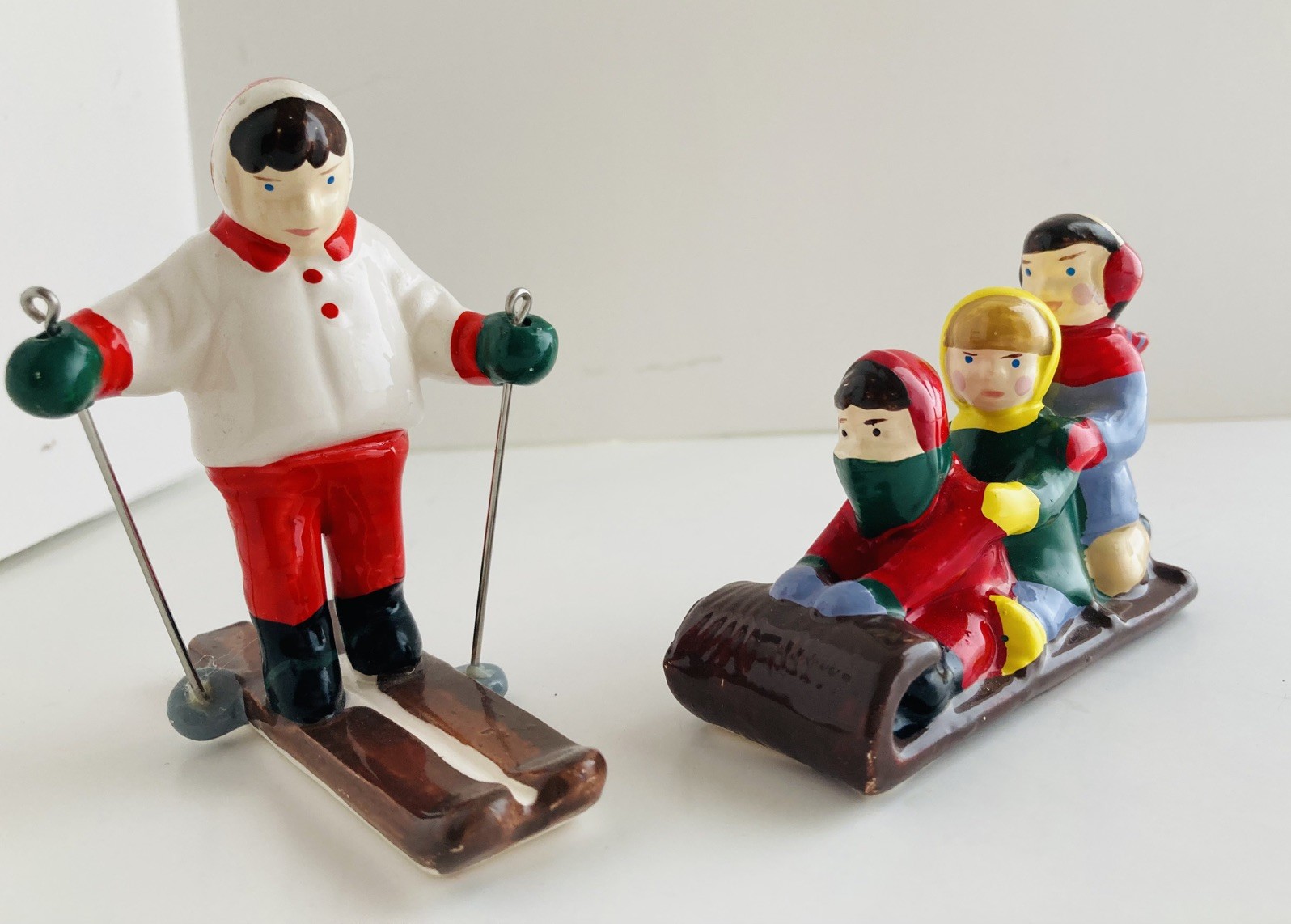Department 56 Snow Village Children on Toboggan Sled and Skier ceramic figurines