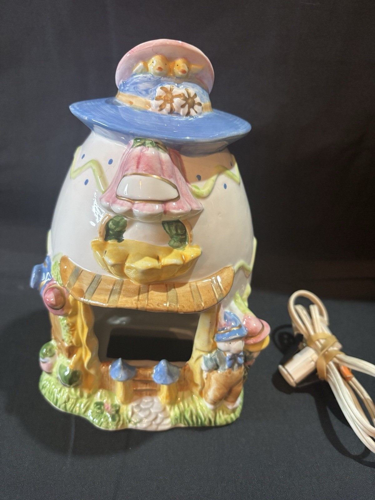 ceramic Easter egg shaped bunny house candle votive holder.